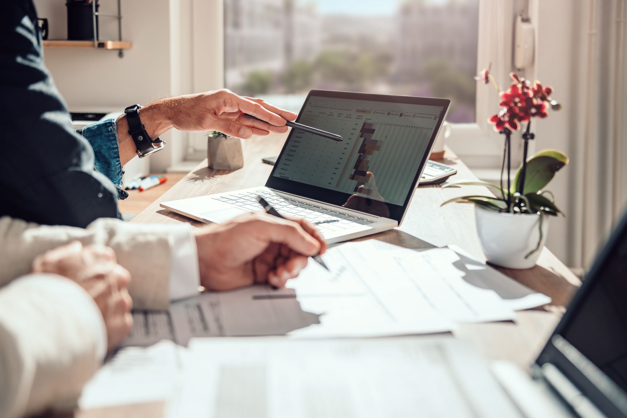 Office space with chart displayed on laptop